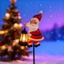 Warm white light Solar Powered Christmas Garden Stake - Metal Santa Claus with Glowing Lantern - Warm White LED Outdoor Decoration - 82cm Height - RnR Galore